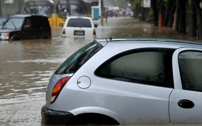 A car submerged in water in the street from intense flooding.