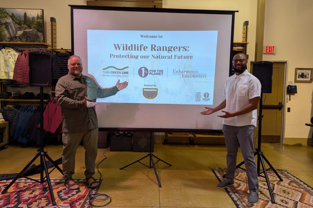 Sean Willmore and Jeffrey D. Stewart posing in front of the wildlife rangers presentation.